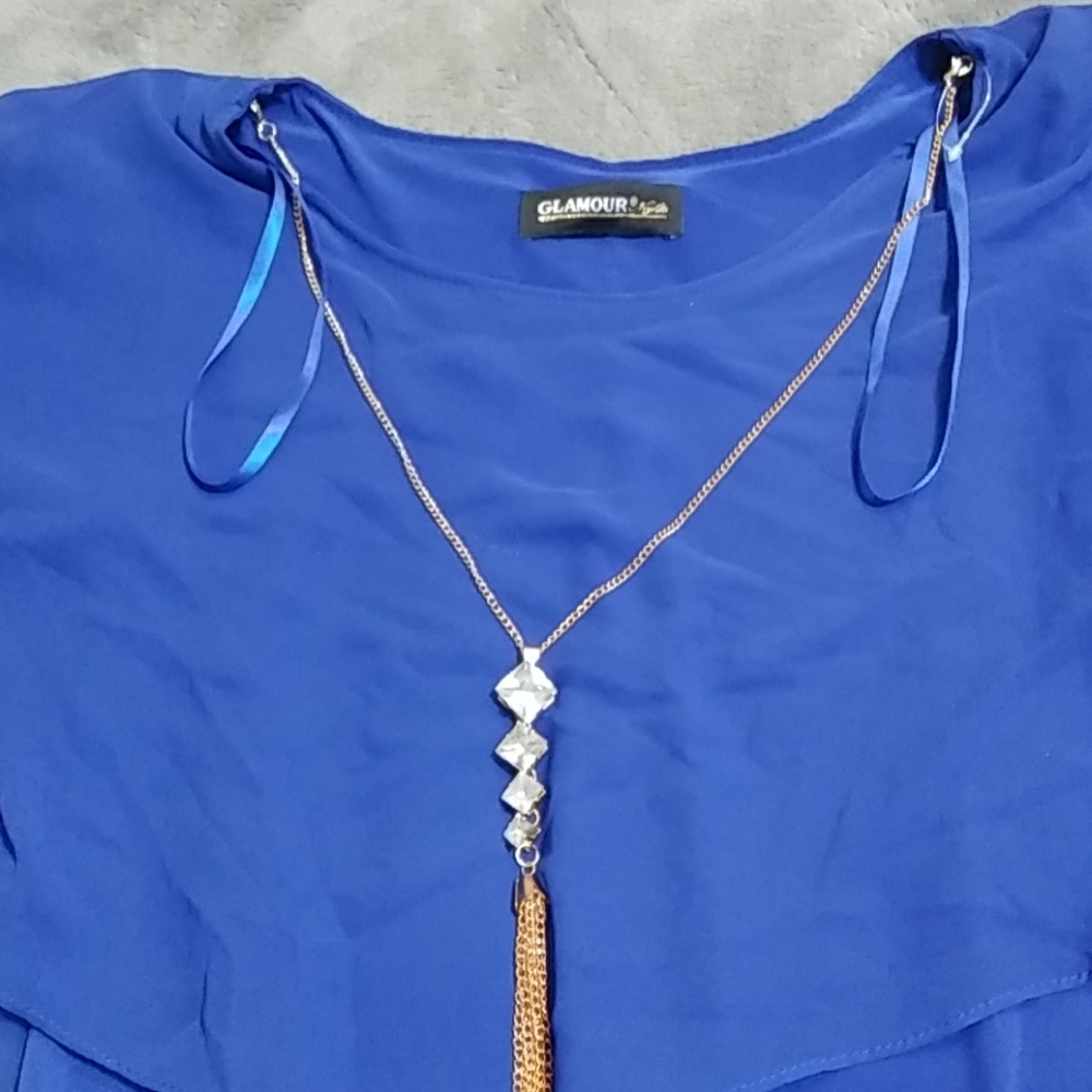 Blue dress with gold chain attached to it
